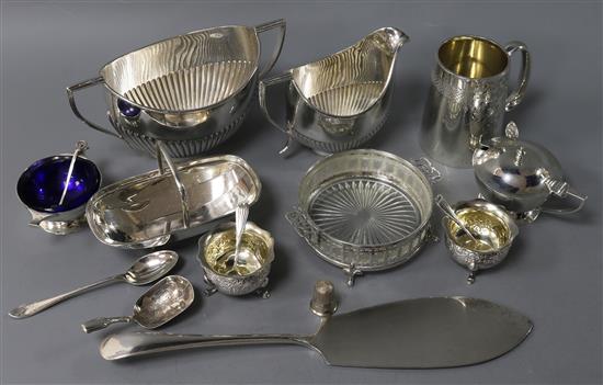 Mixed silver, to include a 19th silver caddy spoon, a silver cream and sugar, four silver condiments, a silver christening mug etc.